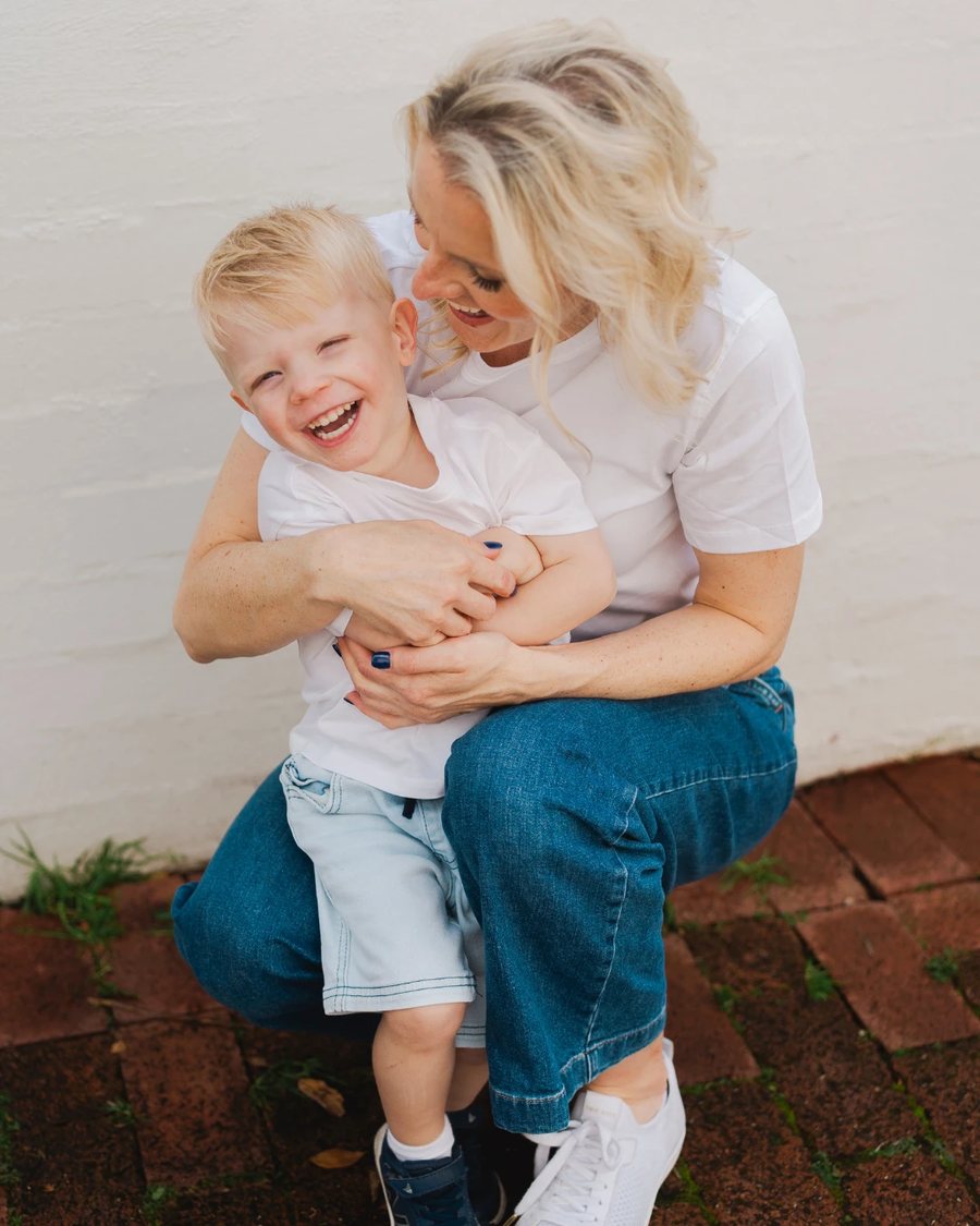 Tash Miller hugging her laughing son Archie