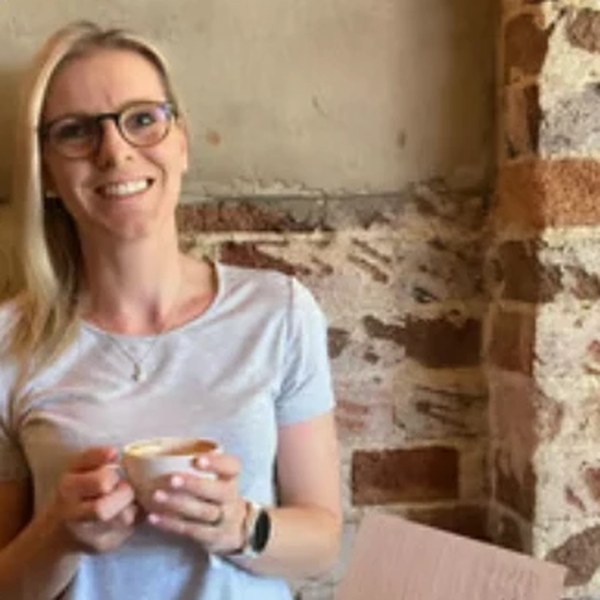 Tash Miller smiling with a coffee