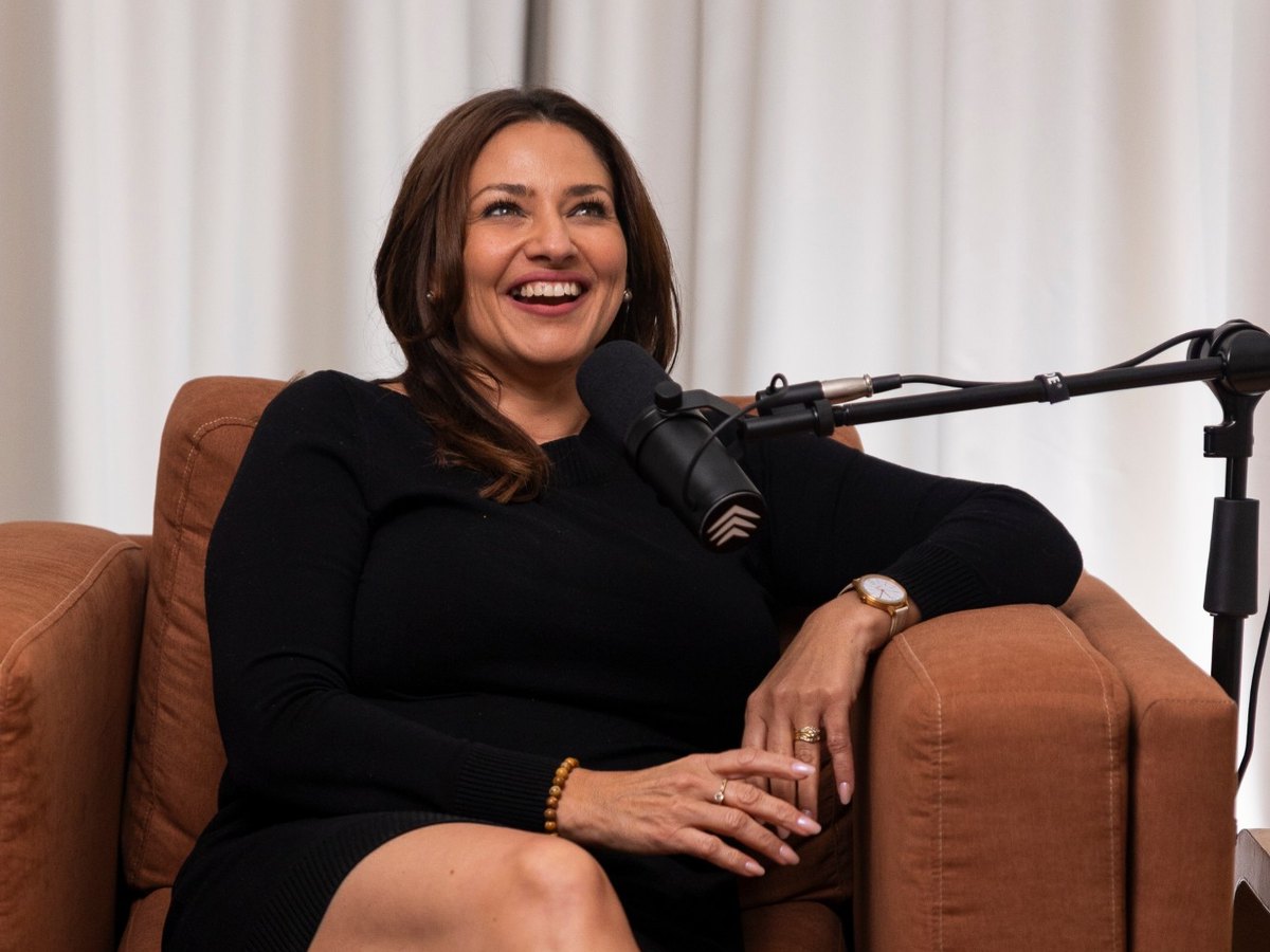 Kelly Vines laughing at the microphone during her 100 Stories Project interview